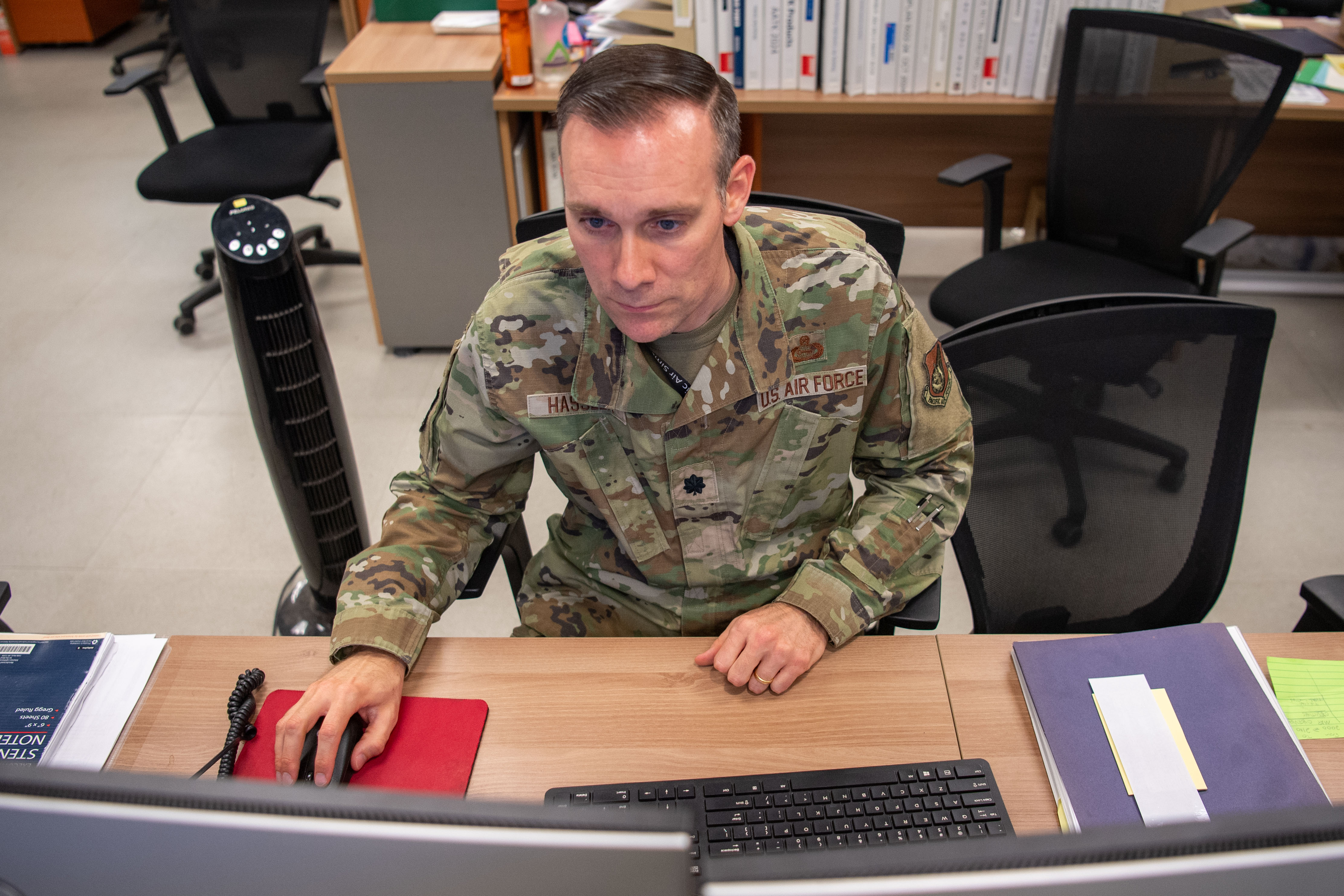 Lt Col sitting at desk looking at computer